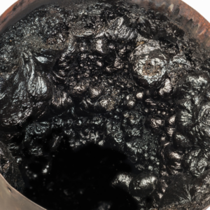 close up view of puffy, tar-like creosote